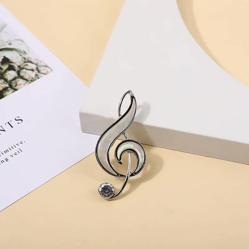Abalone shell musical note brooch